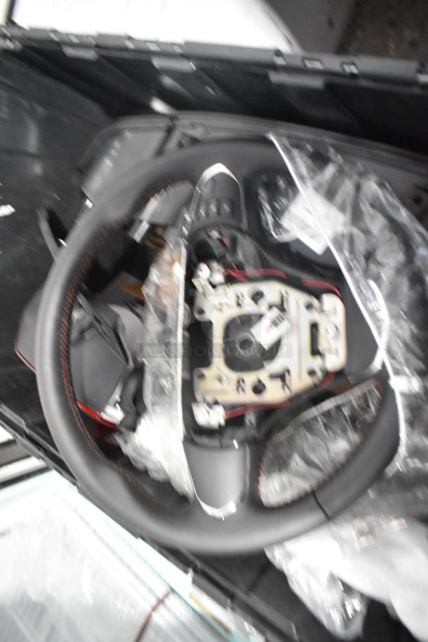 Lot of new car parts including brake light, Cadillac valve stem caps in black poly bin.