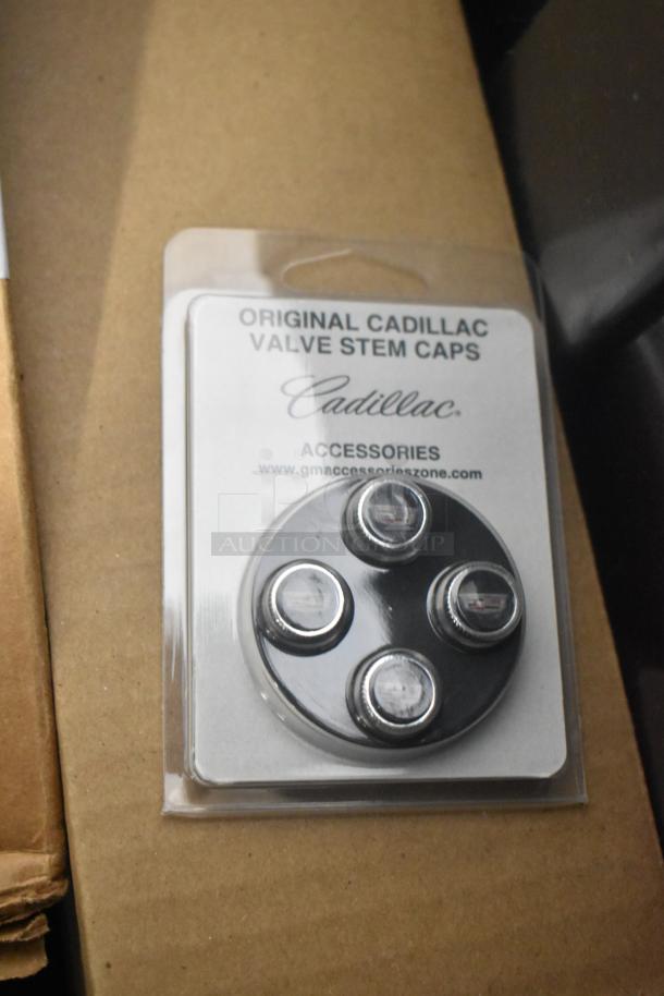 BRAND NEW Cadillac valve stem caps, in original packaging. Includes four caps in a black poly bin.