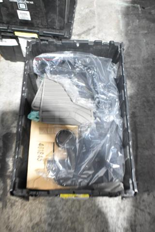 Brand new car parts in black poly bin, includes car mats, packaged in clear plastic, pristine condition.