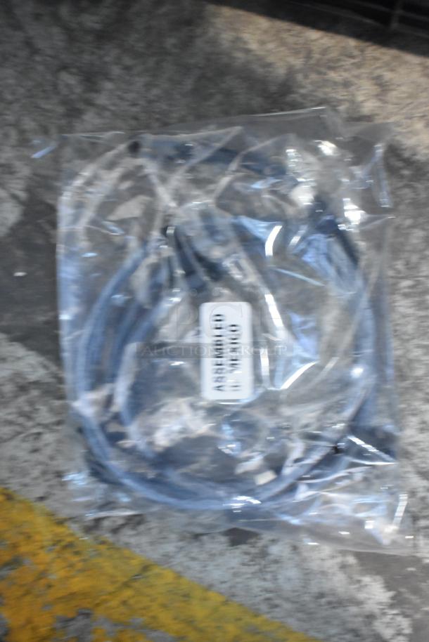 A clear plastic bag containing a car part with a label reading "Assembled in Mexico" inside a poly bin. Brand new condition.