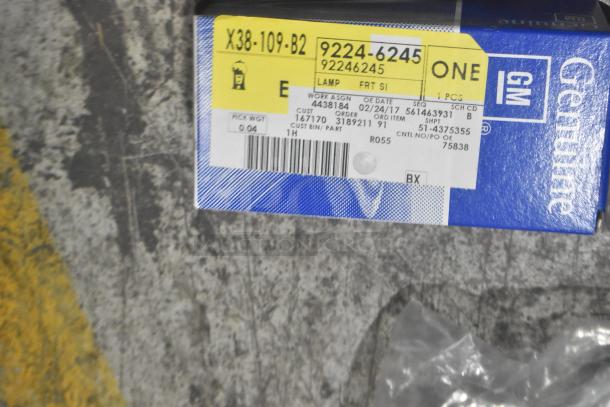 Brand new GM Chevy Camaro front driver side marker lamp in box, model 92246245, genuine GM label visible.