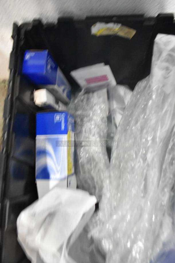 Lot of brand new car parts in a black poly bin, including a GM Chevy Camaro front driver side marker lamp (92246245).