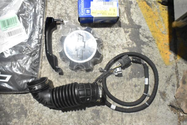 Brand new lot of car parts in black poly bin, includes GM Chevy Camaro front driver side marker lamp (92246245).