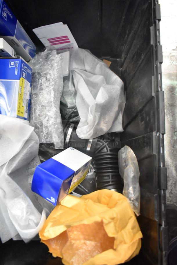 Brand new GM Chevy Camaro front driver side marker lamp (92246245) in a black poly bin with various car parts.