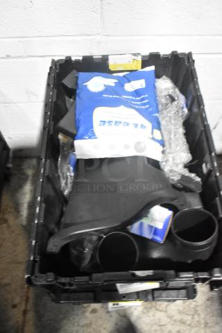 Brand new lot of assorted car parts in black poly bin, includes panels and various components.