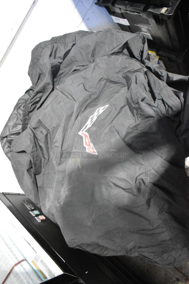 "Lot of car parts with Corvette bags in black poly bin. Brand new condition. Visible logos on bags."