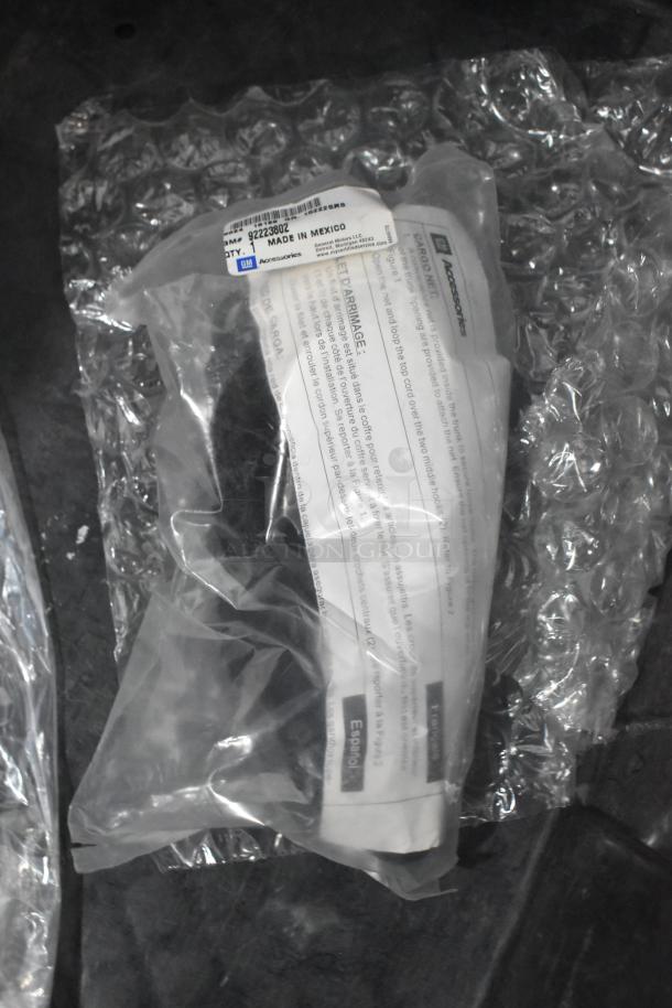 Brand new car parts in sealed packaging, GM label indicating "Made in Mexico," in a black poly bin with bubble wrap.