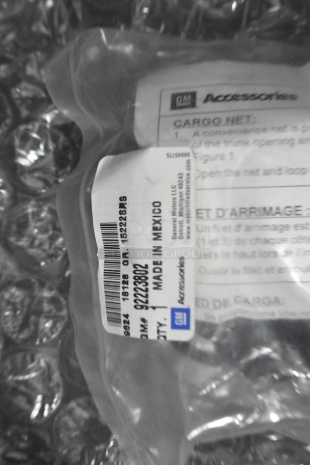Brand new car parts in sealed packaging with a GM Accessories label displaying part number 92223802, made in Mexico.