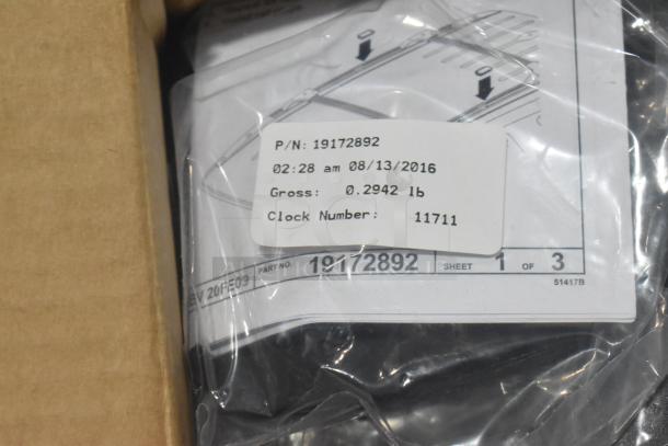 Lot of car parts including GM 84221510 and GM 25790357, new in black poly bin. Parts are bagged with visible labels.