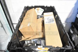 Lot of new car parts in black poly bin, includes GM 10424821 grille assembly, GM 19201541 lug nuts, GM 19244300 cargo net.