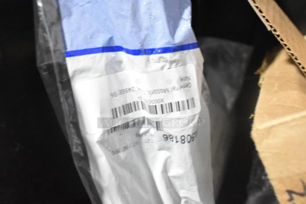 Brand new car parts in black poly bin including GM 10424821 grille, GM 19201541 lug nuts, and GM 19244300 cargo net.