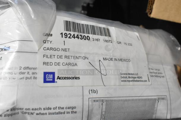 Brand new GM 19244300 vertical cargo net, labeled in packaging. Made in Mexico, part of a lot of various car parts.