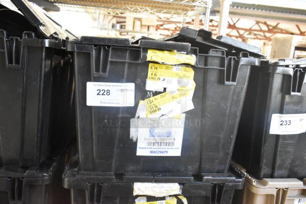 Brand new lot of various car parts in a black poly bin, including Corvette steering wheels. Bin marked "228" with auction details.