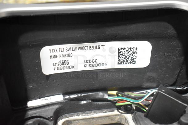 Brand new car parts lot, including Corvette steering wheels, in black poly bin. Label shows part numbers and "Made in Mexico."