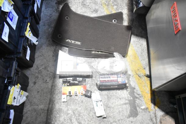 Lot of various new car parts including ATS car mats and Hawk Racing disc brake pads, all in a black poly bin.