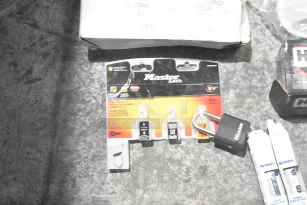 Lot of new car parts in black poly bin, includes car mats, Hawk Racing disc brake pads, Master Lock packaging.
