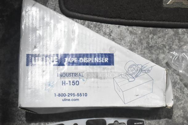 Brand new lot of car parts in a black poly bin including car mats, Hawk Racing disc brake pads, Uline tape dispenser box.