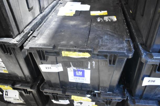 Black poly bin with GM 92223802 cargo net and tape rolls, labels indicating "Brand New!" condition and auction lot info.