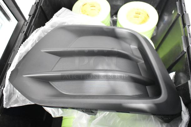 Brand new GM 92223802 cargo net, black poly bin with green tape rolls visible; ideal for car part storage.