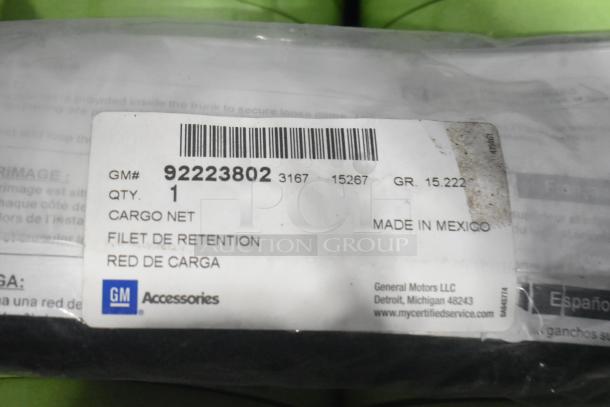 Brand new GM 92223802 cargo net, visible label with part number, in black poly bin with black tape rolls, made in Mexico.