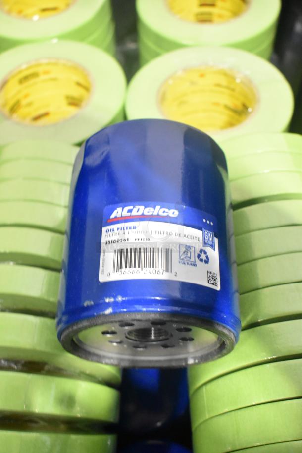 Lot of car parts, featuring ACDelco oil filter, GM 92223802 cargo net, tape rolls. New in black poly bin.