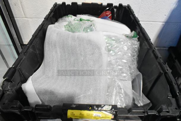 Brand new lot of car parts, including steering wheel and light panels, in black poly bin. Sealed, packed with labels visible.