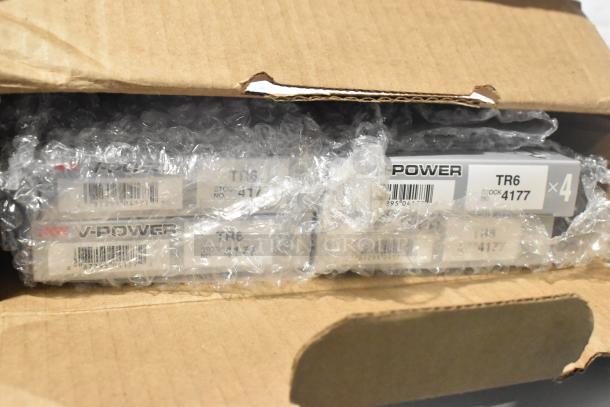 Brand new lot of NGK V-Power spark plugs, model TR6, stock no. 4177, in bubble wrap inside a cardboard box.