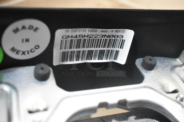 Barcode and "Made in Mexico" labels on a brand new car part, model GM45M223N003. Part of a lot including car mats.