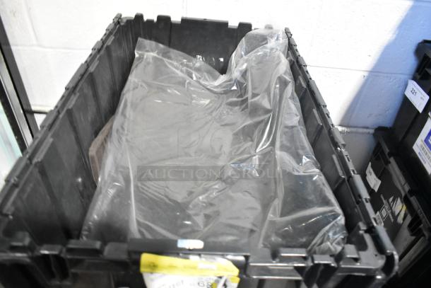 Lot of new car parts including mats, in a black poly bin; parts wrapped in clear plastic, indicating brand-new condition.