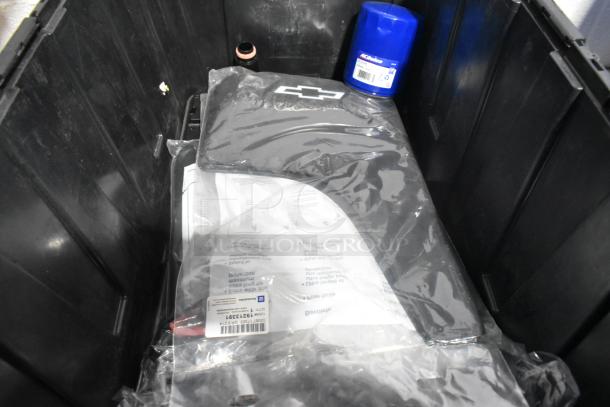 Lot of car parts including black car mats in a poly bin; includes ACDelco filter, in brand new condition.