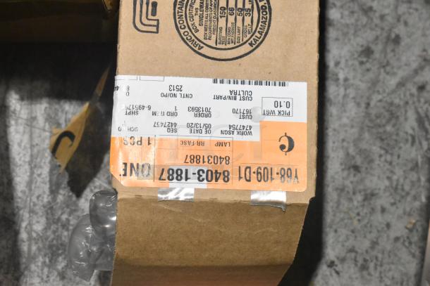 A cardboard box with a label indicating contents as various car parts. Packaged securely with air cushioning inside.