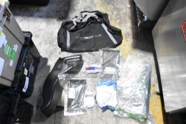 Brand new lot of various car parts, including a Camaro bag, in a black poly bin. Items are in sealed packaging.