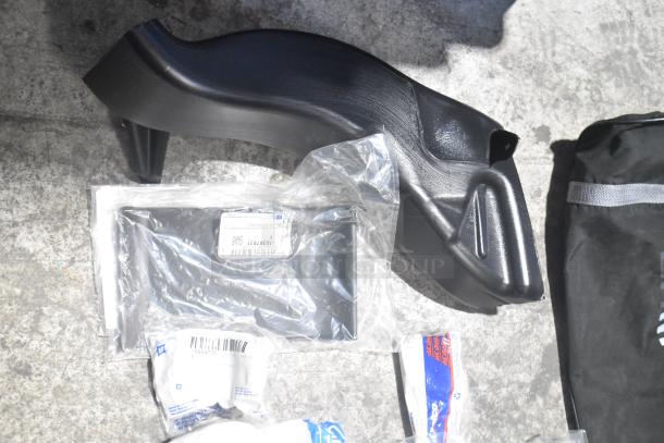 Lot of brand new car parts in black poly bin, includes Camaro bag. Parts labeled with product codes, in original packaging.