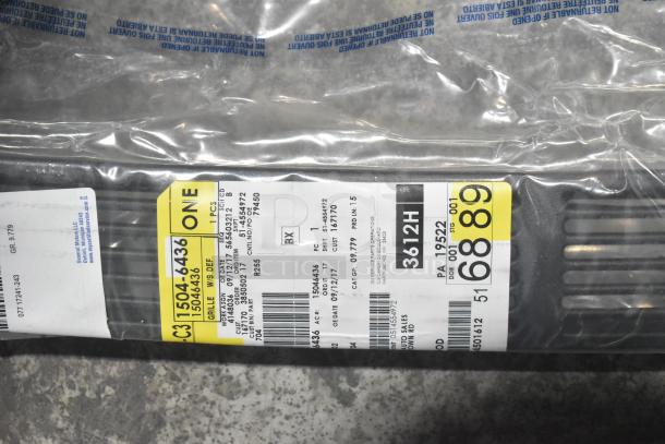 Brand new car parts lot with spark plugs. Includes black grille in poly bin. Labels show part numbers and details.