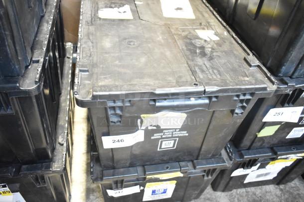 Brand new black poly bin with various car parts, including GM 84044906 brake deflector, labeled "Property of GM."