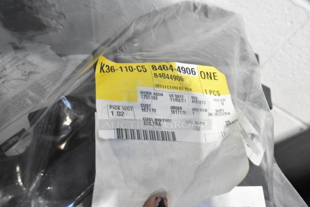 Brand new GM 84044906 brake deflector in packaging with label details. Includes work assignment, order number, and weight.