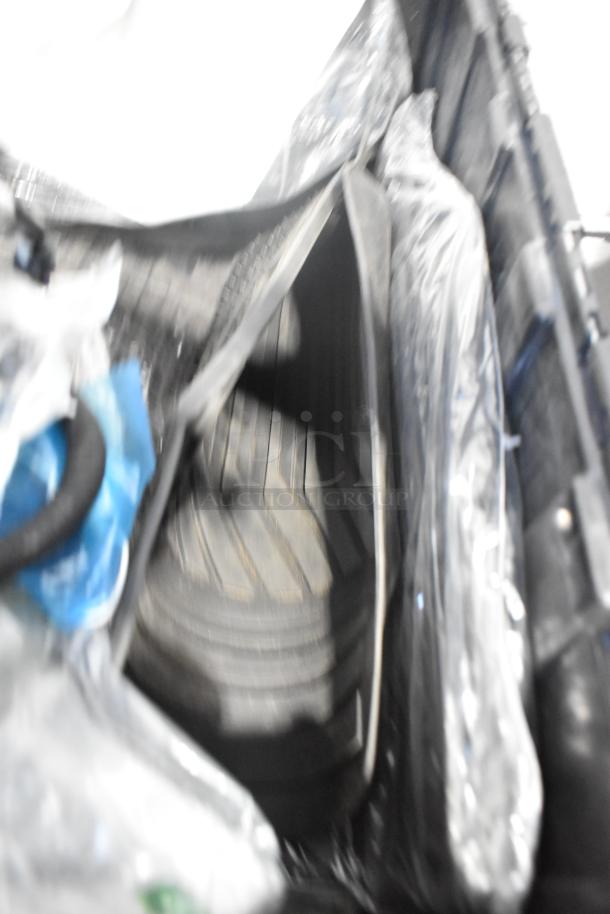 Lot of various brand new car parts in black poly bin; includes GM 84044906 brake deflector and handle.