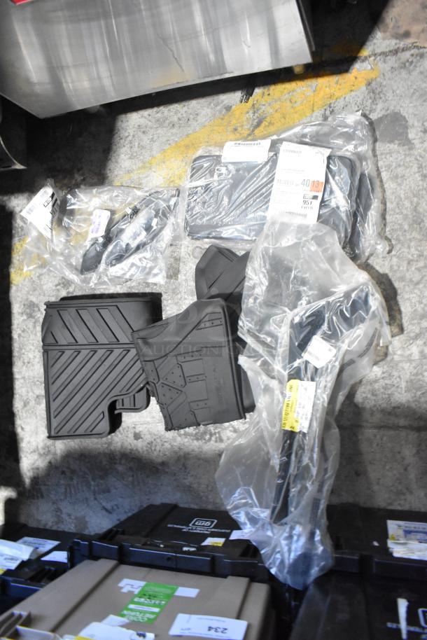 Brand new lot of car parts including car mats, various components in a black poly bin, tags with part numbers visible.