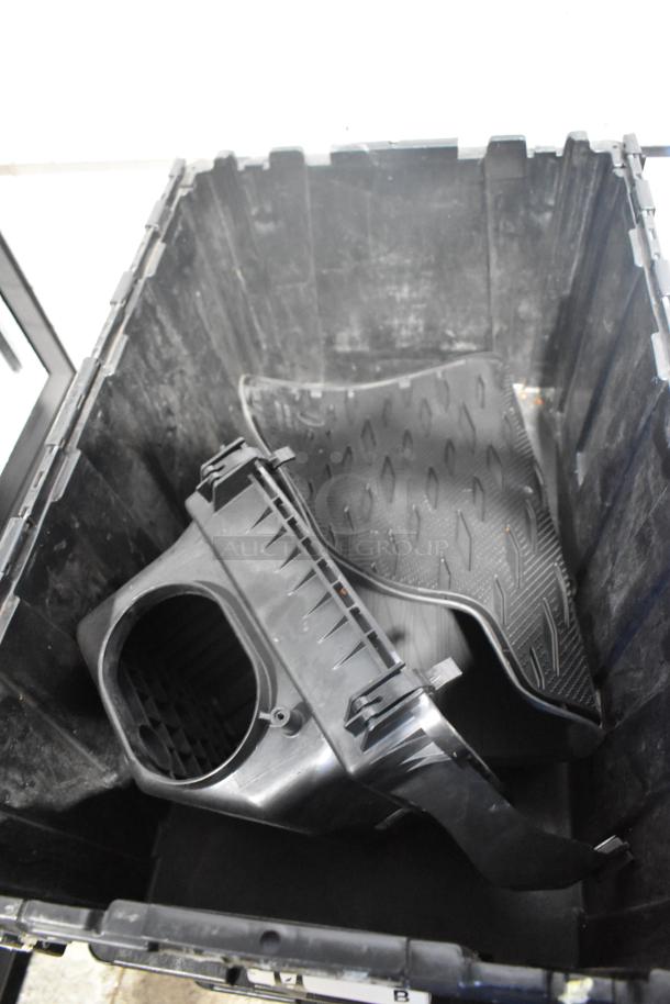 Brand new car parts, including black car mats, in black poly bin; suitable for various vehicles.