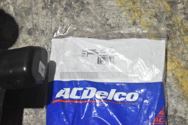 Brand new lot of car parts, including a side view mirror. ACDelco packaging visible with part number 20956479.