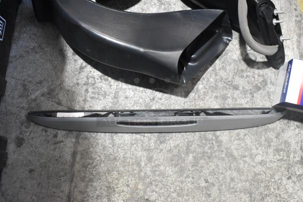 Brand new car parts lot including a side view mirror in black poly bin. Box labeled "ACDelco" visible.