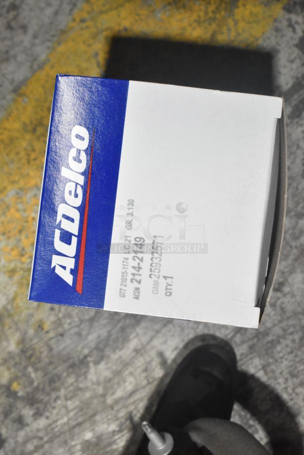 ACDelco box labeled "2412149", part of a brand new lot of car parts, including a side view mirror in a black poly bin.