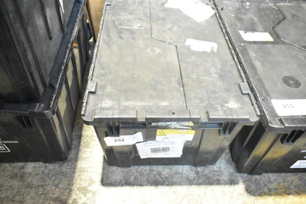 Black poly bin filled with brand new car parts, including labels and tags indicating contents and condition.