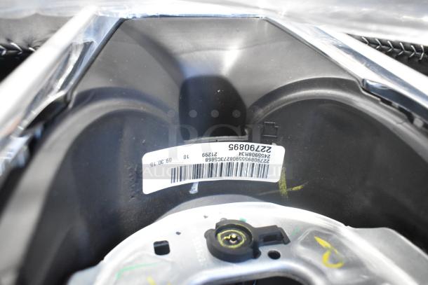New car part with visible label showing barcode and serial number "22790895" inside black poly bin.