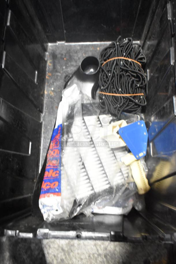 Brand new car parts including filters, straps, and accessories in a black poly bin. Ideal for automotive use.