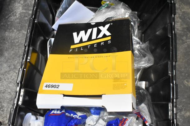 Lot of brand new car parts including filters and panels in black poly bin. Wix Filters box visible. Item code: 46902.