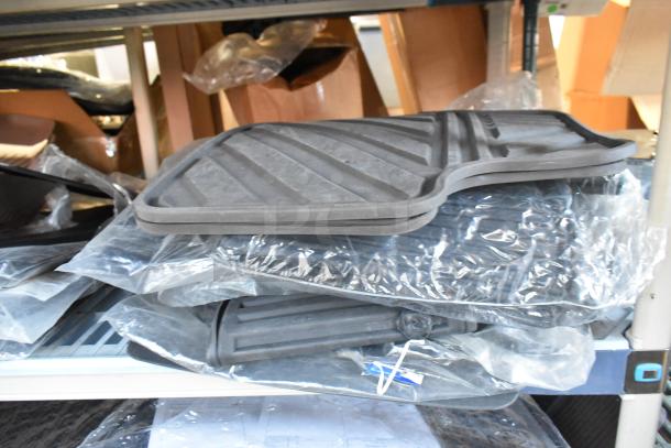 Brand new car parts lot including car mats in original packaging on a shelf, showing pristine condition and variety.