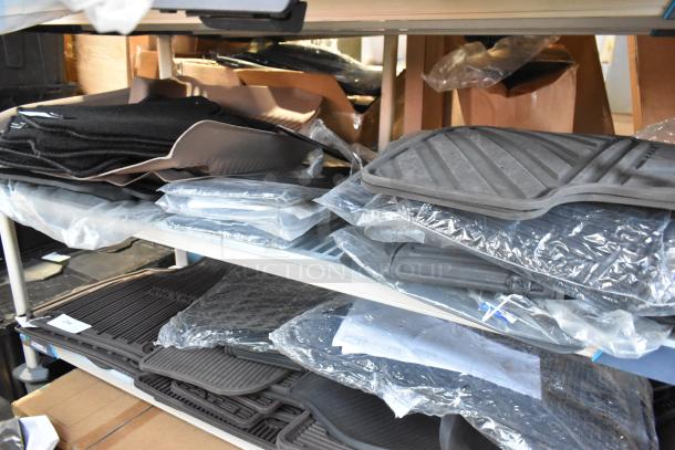 Tier shelf displaying a lot of brand new car parts including black and gray car mats in original packaging.