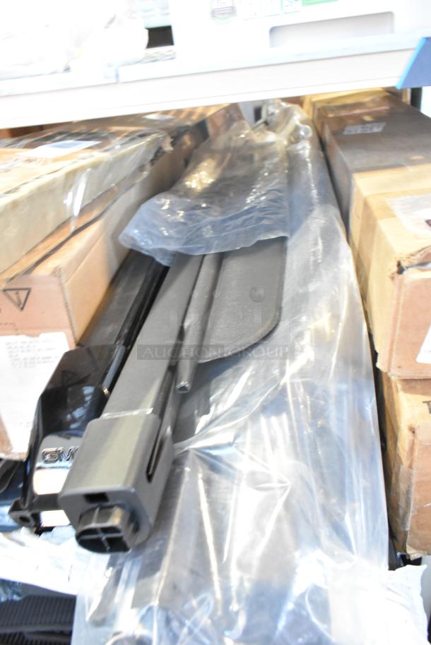 Brand new tier lot of car parts, including GM 20862098 mirror assembly, in original packaging with visible GM label.