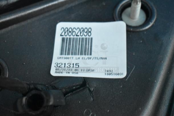 Label on GM 20862098 Mirror Assy, showing model details and barcode. Made in USA, indicates new condition.